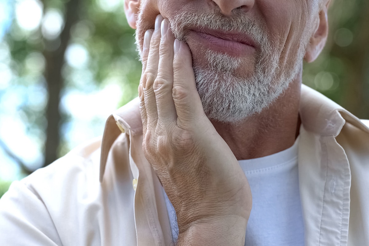 Old Man Holding Mouth Image